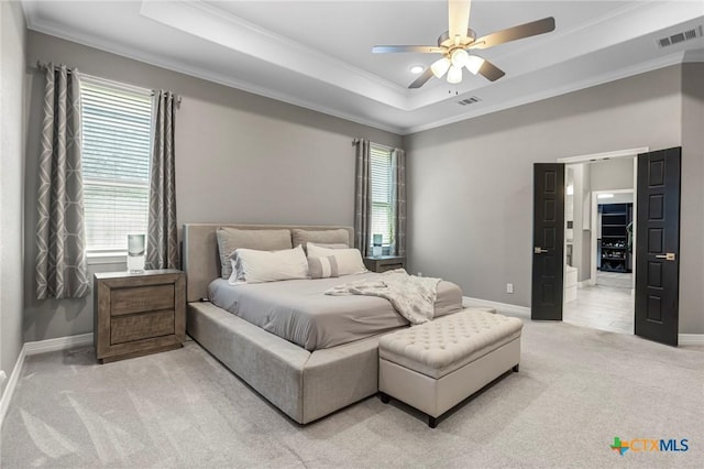 bedroom featuring light colored carpet, visible vents, crown molding, and multiple windows