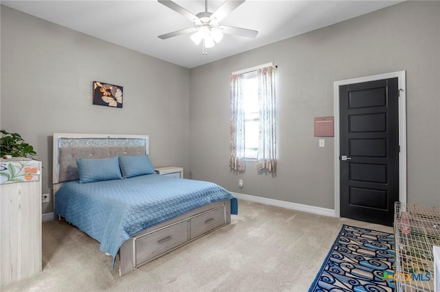 bedroom with baseboards, a ceiling fan, and light colored carpet