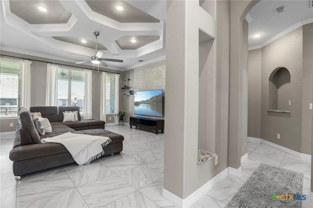 living room featuring ornamental molding, a ceiling fan, arched walkways, and baseboards