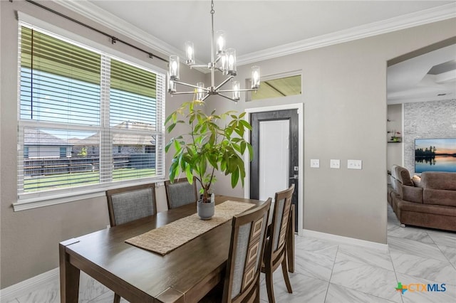dining area featuring baseboards, a notable chandelier, and crown molding