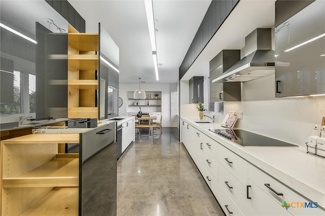 kitchen featuring range hood, sink, black electric cooktop, white cabinets, and pendant lighting