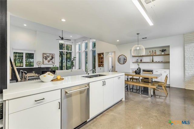 kitchen featuring white cabinetry, decorative light fixtures, sink, stainless steel dishwasher, and ceiling fan