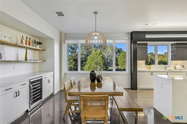 dining area with indoor wet bar and beverage cooler