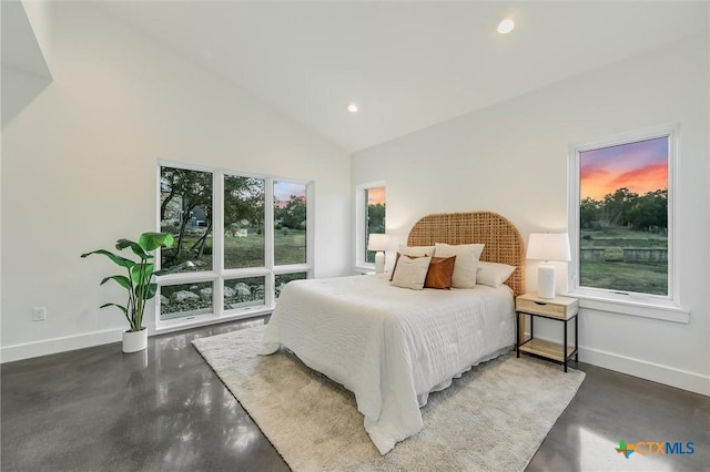 bedroom featuring multiple windows and high vaulted ceiling