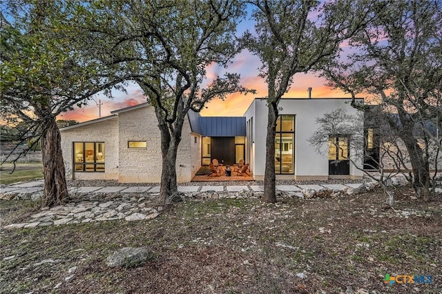 view of back house at dusk