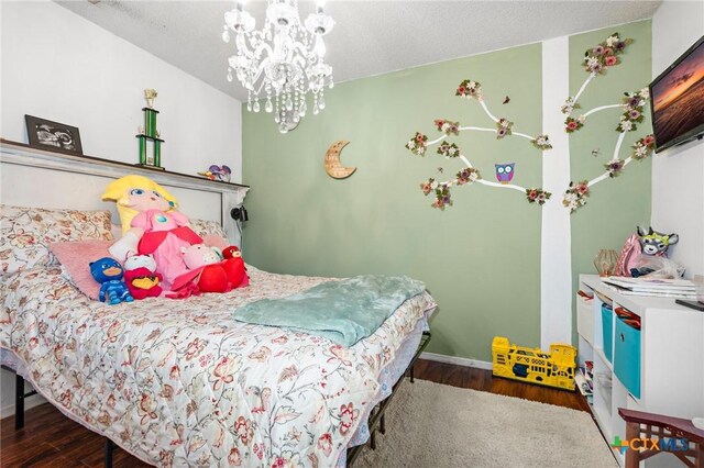 109 E Moonlight Dr, Robinson, TX 76706 - bedroom with dark wood-type flooring and an inviting chandelier