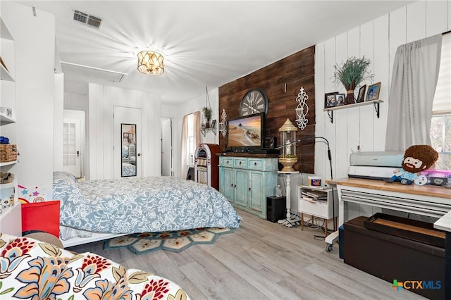 109 E Moonlight Dr, Robinson, TX 76706 - bedroom featuring light hardwood / wood-style flooring and wooden walls