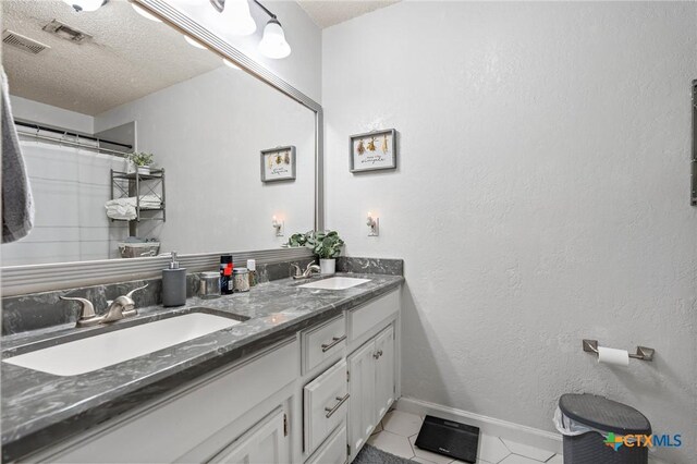 109 E Moonlight Dr, Robinson, TX 76706 - bathroom featuring vanity, tile patterned flooring, and a textured ceiling