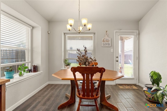 dining space with an inviting chandelier, plenty of natural light, and dark hardwood / wood-style flooring