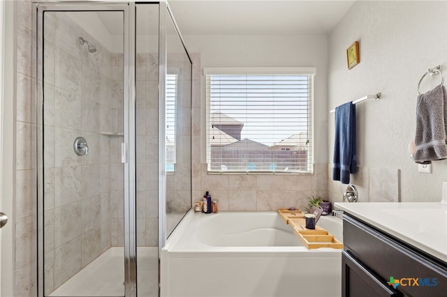 bathroom with vanity and independent shower and bath