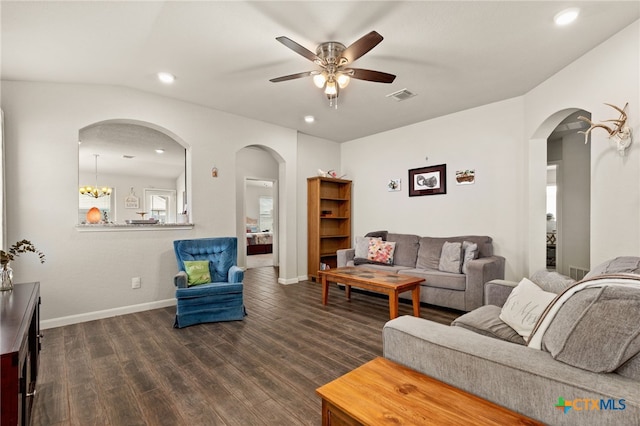 living room featuring ceiling fan with notable chandelier, lofted ceiling, and dark hardwood / wood-style floors