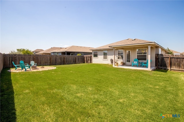 back of property with a lawn and a patio area