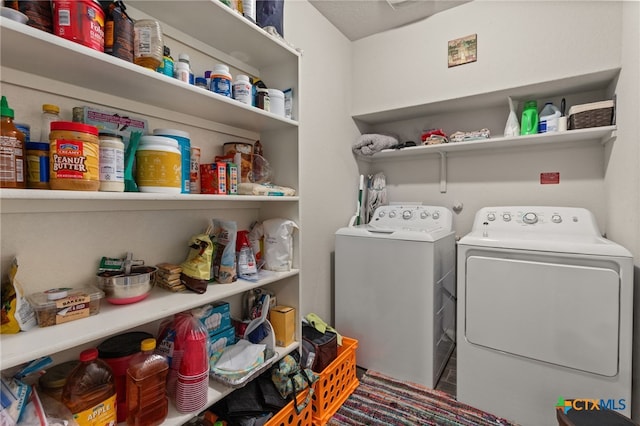 clothes washing area featuring washer and clothes dryer