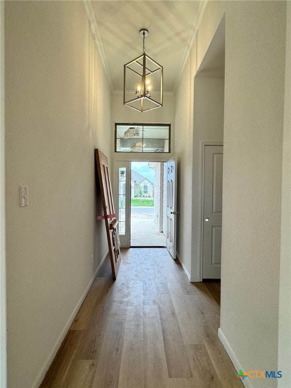 1249 Bending Branch Way, Temple, TX 76502 - entrance foyer featuring ornamental molding, a chandelier, light wood-type flooring, baseboards, and a high ceiling