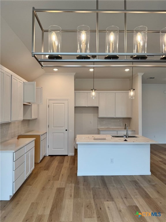 1249 Bending Branch Way, Temple, TX 76502 - kitchen featuring a sink, light wood-style floors, tasteful backsplash, and white cabinets