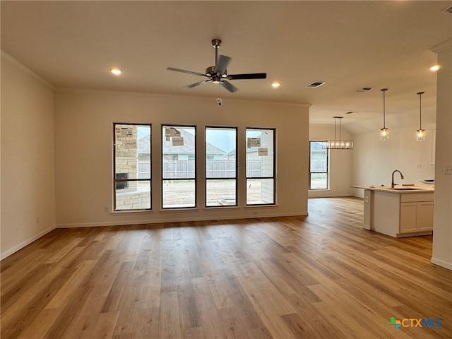 1249 Bending Branch Way, Temple, TX 76502 - unfurnished living room with ornamental molding, baseboards, a ceiling fan, a sink, and light wood-style floors