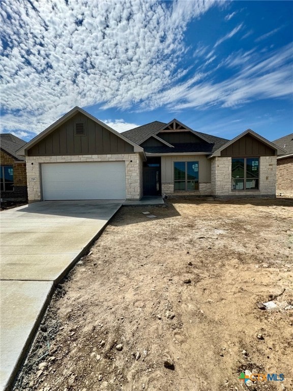 1249 Bending Branch Way, Temple, TX 76502 - view of front facade with a garage, driveway, board and batten siding, and roof with shingles
