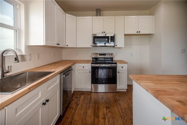 177 Powderhorn Ln, Port Lavaca, TX 77979 - kitchen featuring appliances with stainless steel finishes, wooden counters, and white cabinets