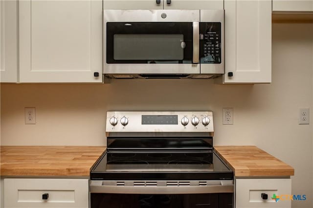 177 Powderhorn Ln, Port Lavaca, TX 77979 - kitchen view of appliances with stainless steel finishes, wooden counters, and white cabinets