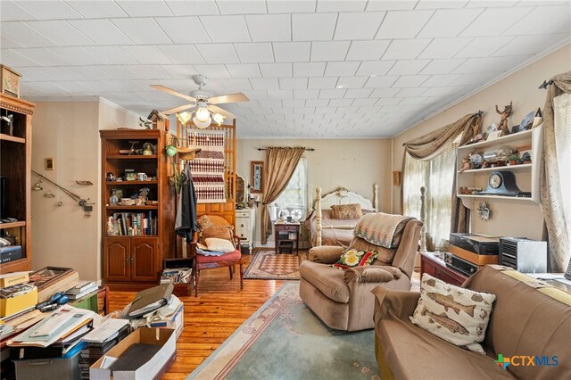 interior space featuring ornamental molding, hardwood / wood-style floors, and ceiling fan