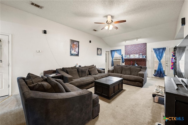 living room with ceiling fan, light colored carpet, a textured ceiling, and vaulted ceiling