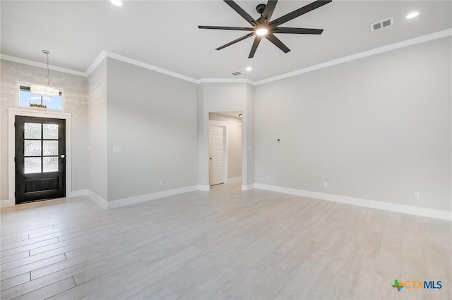 foyer featuring ornamental molding, visible vents, light wood-style flooring, and baseboards