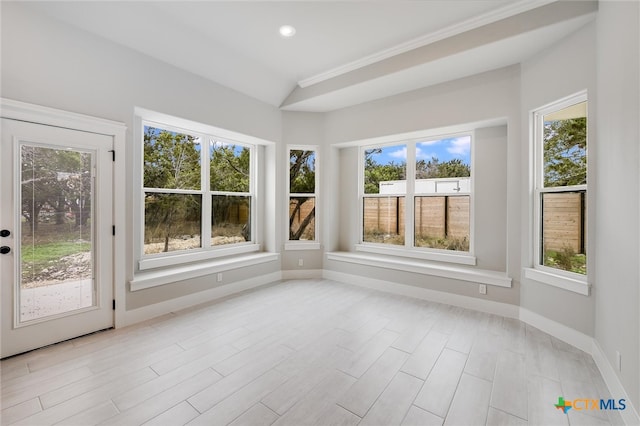 unfurnished sunroom with lofted ceiling