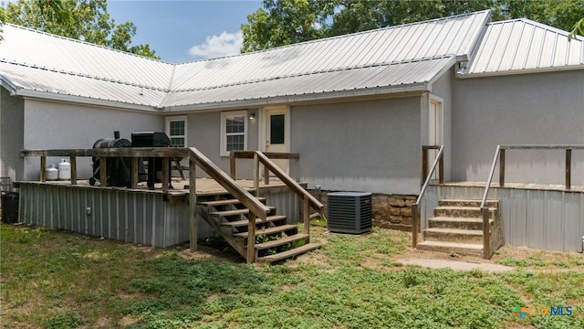 607 S Main St, Lampasas, TX 76550 - rear view of house featuring a metal roof, a wooden deck, stucco siding, and stairway