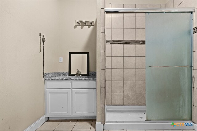 607 S Main St, Lampasas, TX 76550 - full bath featuring a shower stall, vanity, and tile patterned flooring