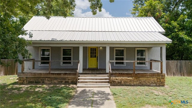 607 S Main St, Lampasas, TX 76550 - view of front of home with stucco siding, a metal roof, and a porch