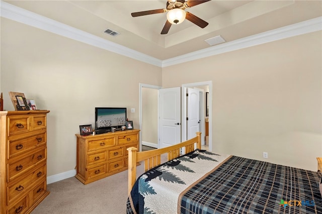 bedroom featuring crown molding, a raised ceiling, light colored carpet, visible vents, and baseboards