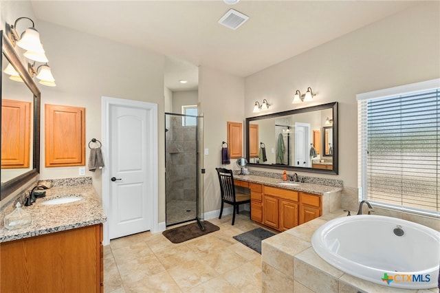 bathroom with a garden tub, a stall shower, a sink, and visible vents