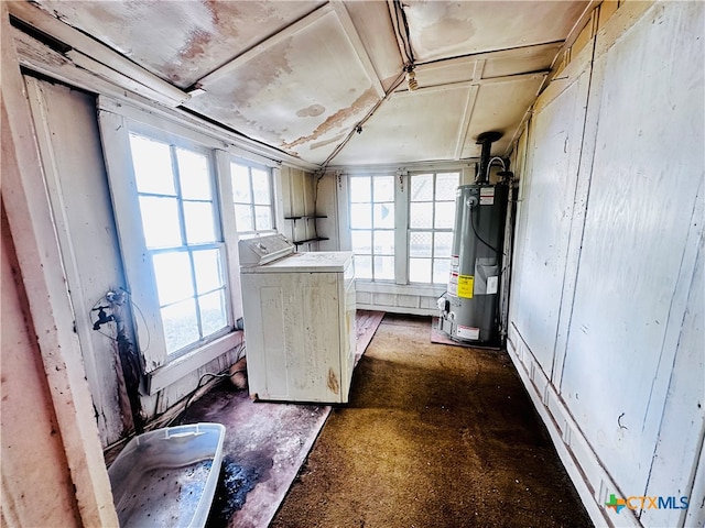 basement featuring washer / clothes dryer, a healthy amount of sunlight, and gas water heater