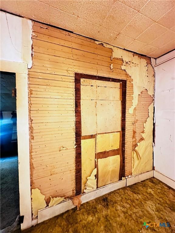 201 Maple St, Yoakum, TX 77995 - unfurnished room with wood walls