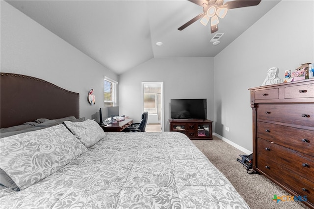 bedroom featuring ceiling fan, connected bathroom, vaulted ceiling, and light colored carpet