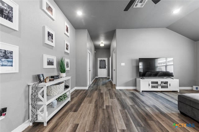 hall featuring dark hardwood / wood-style floors and lofted ceiling