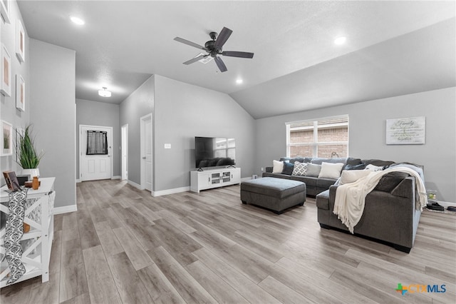 living room featuring ceiling fan, light hardwood / wood-style flooring, and lofted ceiling