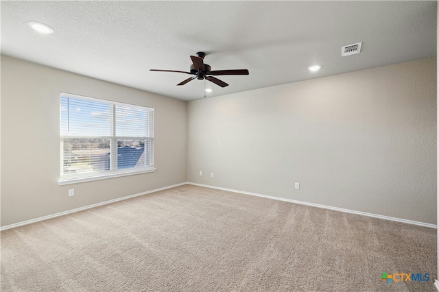 empty room featuring light carpet and ceiling fan