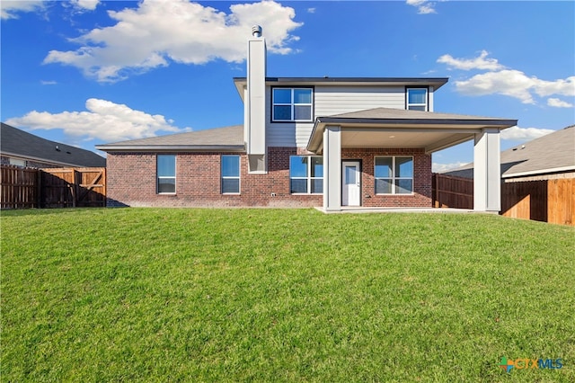 rear view of property with a yard