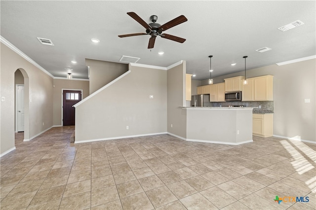 unfurnished living room with ceiling fan, ornamental molding, and light tile patterned floors