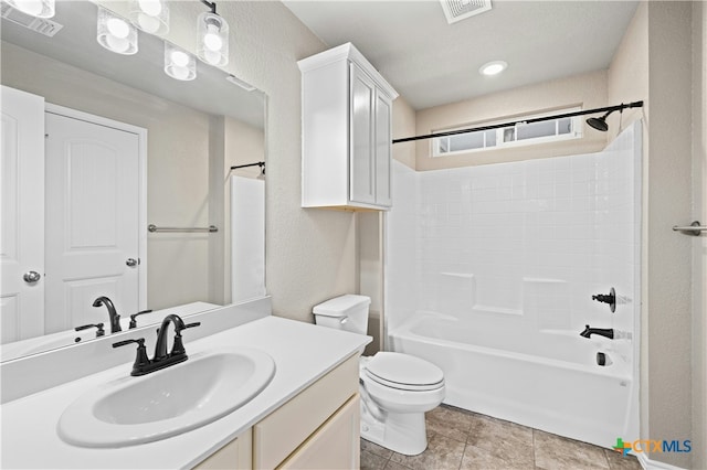 full bathroom featuring toilet, vanity, and tub / shower combination