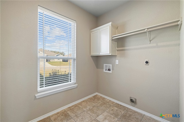 clothes washing area featuring hookup for an electric dryer, cabinets, and hookup for a washing machine