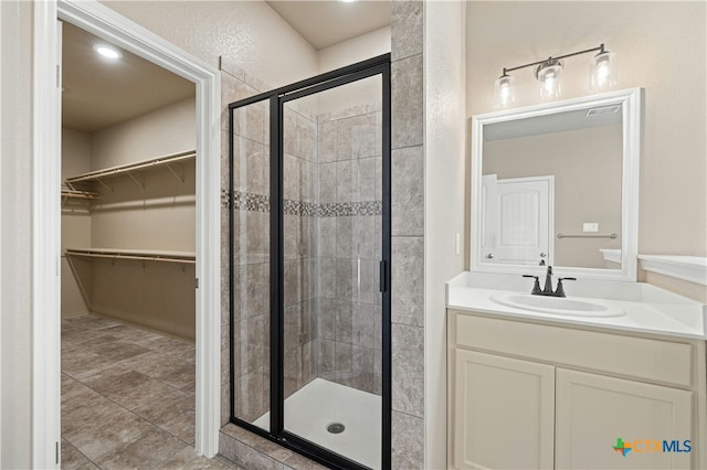 bathroom featuring vanity and a shower with shower door