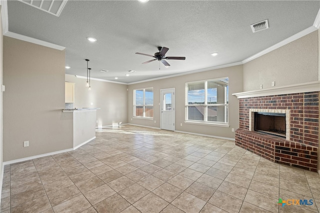 unfurnished living room featuring crown molding, a brick fireplace, ceiling fan, light tile patterned floors, and a textured ceiling