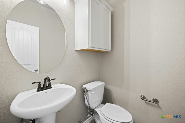 bathroom with toilet and sink