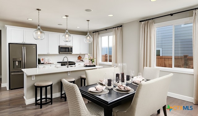 dining area featuring dark wood-type flooring and sink