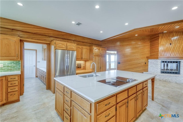 614 County Road 207, Burnet, TX 78611 - kitchen featuring black electric stovetop, a sink, stainless steel refrigerator, tasteful backsplash, and recessed lighting