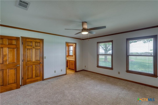 614 County Road 207, Burnet, TX 78611 - unfurnished bedroom featuring light carpet, baseboards, crown molding, and ensuite bath