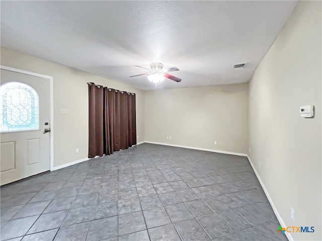 foyer entrance with ceiling fan