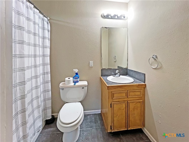 bathroom featuring toilet, vanity, tile patterned flooring, and curtained shower